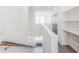 Bright hallway features hardwood floors, a staircase with a coat rack, built-in shelves, and a neutral color scheme at 379 Pratt Se Dr # 408, Atlanta, GA 30315