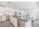 Open-concept kitchen with island, stainless appliances, and hardwood floors at 379 Pratt Se Dr # 408, Atlanta, GA 30315