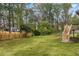 Expansive green backyard space with a wooden fence, providing a serene and private setting at 1185 Winterberry Ct, Lawrenceville, GA 30043