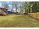A large backyard with ample green space and a fenced perimeter offering privacy at 1185 Winterberry Ct, Lawrenceville, GA 30043