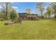 A view of a backyard with a deck, storage shed, and green lawn at 1185 Winterberry Ct, Lawrenceville, GA 30043