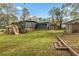 A spacious backyard with an outbuilding, wooden planters, and well-maintained lawn at 1185 Winterberry Ct, Lawrenceville, GA 30043