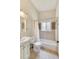 Bright bathroom with a tiled shower and tub combo, a white vanity, and a window for natural light at 1185 Winterberry Ct, Lawrenceville, GA 30043