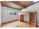 Bedroom with hardwood floors, loft bed, built-in shelves, and a large window offering natural light at 1185 Winterberry Ct, Lawrenceville, GA 30043