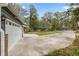 Driveway leading to a home with an attached garage and mature trees in the background at 1185 Winterberry Ct, Lawrenceville, GA 30043