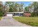 Lovely home exterior with a spacious front lawn, brick details, and attached garage at 1185 Winterberry Ct, Lawrenceville, GA 30043