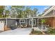 Stylish home exterior featuring gray siding, brick accents, covered porch, and well-maintained landscaping at 1185 Winterberry Ct, Lawrenceville, GA 30043