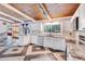 Spacious kitchen features white cabinets, modern appliances, granite countertops and decorative tile flooring at 1185 Winterberry Ct, Lawrenceville, GA 30043