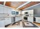 Bright kitchen featuring sleek stainless steel appliances, white cabinets, granite countertops and decorative tile flooring at 1185 Winterberry Ct, Lawrenceville, GA 30043