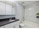 Updated bathroom features marble-patterned tile in shower, sleek vanity with dark countertop, and modern fixtures at 1255 Branch Dr, Tucker, GA 30084