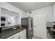 This kitchen features white cabinets, stainless steel appliances, and grey countertops at 1255 Branch Dr, Tucker, GA 30084