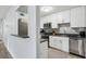 This kitchen features white cabinets, stainless steel appliances, and a grey backsplash at 1255 Branch Dr, Tucker, GA 30084