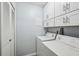 Bright laundry room with white cabinets and modern washing machine and dryer at 1255 Branch Dr, Tucker, GA 30084