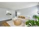 Bright living room featuring a plush white sofa, a round wooden coffee table, and tasteful decorations at 1255 Branch Dr, Tucker, GA 30084