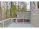 Spacious outdoor deck with wooden railings and lattice work with views of the wooded backyard at 1343 Riverview Run Ln, Suwanee, GA 30024