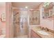 Beautifully remodeled bathroom with glass enclosed shower and granite countertop sink at 1343 Riverview Run Ln, Suwanee, GA 30024