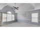 Bedroom featuring vaulted ceilings, ceiling fan, and large windows with views of the surrounding neighborhood at 1343 Riverview Run Ln, Suwanee, GA 30024