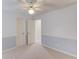Neutral carpet and blue walls accent this bedroom with white painted doors at 1343 Riverview Run Ln, Suwanee, GA 30024