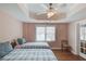 Bright bedroom with two twin beds, wood floors, and large windows at 1343 Riverview Run Ln, Suwanee, GA 30024