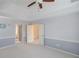 Spacious bedroom with a ceiling fan, neutral color scheme, and ample closet space at 1343 Riverview Run Ln, Suwanee, GA 30024