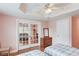 Bedroom featuring ceiling fan, wood floors, and mirrored closet doors at 1343 Riverview Run Ln, Suwanee, GA 30024