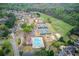 Aerial view of community amenities with swimming pool, tennis courts and playground at 1343 Riverview Run Ln, Suwanee, GA 30024
