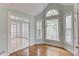 Bright dining area with beautiful french doors, hardwood flooring, and many windows overlooking nature at 1343 Riverview Run Ln, Suwanee, GA 30024