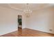 Refined dining room with hardwood floors, decorative chandelier, and detailed ceiling trim at 1343 Riverview Run Ln, Suwanee, GA 30024