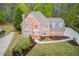 Attractive brick home featuring a well manicured lawn, flowering shrubs, and a welcoming walkway at 1343 Riverview Run Ln, Suwanee, GA 30024