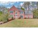 Charming two-story brick home with a manicured lawn and beautiful landscaping in a desirable neighborhood at 1343 Riverview Run Ln, Suwanee, GA 30024
