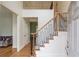 Bright foyer featuring a staircase with modern iron railings, hardwood floors, and an open layout at 1343 Riverview Run Ln, Suwanee, GA 30024