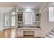 Hallway with a granite topped desk space and built-in storage with access to the kitchen and living area at 1343 Riverview Run Ln, Suwanee, GA 30024