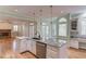 Open kitchen with a large island, granite countertops, and a stainless steel dishwasher at 1343 Riverview Run Ln, Suwanee, GA 30024