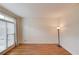 Elegant living room featuring hardwood floors, custom wall trim, large windows and a sleek floor lamp at 1343 Riverview Run Ln, Suwanee, GA 30024