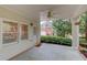 Covered patio featuring a ceiling fan, stone pavers, and access to the home and backyard at 1343 Riverview Run Ln, Suwanee, GA 30024