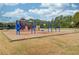 Community playground area with swings, slides, and sports court at 1343 Riverview Run Ln, Suwanee, GA 30024