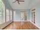 Bright sunroom featuring hardwood floors, large windows, and access to the home's interior through French doors at 1343 Riverview Run Ln, Suwanee, GA 30024