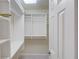 Walk-in closet with built-in shelving and ample storage space at 1343 Riverview Run Ln, Suwanee, GA 30024