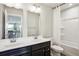 Inviting bathroom boasts double sinks, an open doorway, and a shower-tub combo at 156 Marchmont Dr, Locust Grove, GA 30248