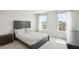 Comfortable bedroom with neutral decor, a modern bedframe, and views of the outdoors at 156 Marchmont Dr, Locust Grove, GA 30248