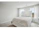 Serene bedroom featuring a cozy bed bathed in soft light from the nearby windows at 156 Marchmont Dr, Locust Grove, GA 30248
