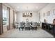 Formal dining room with a large table, modern decor, and ample natural light at 156 Marchmont Dr, Locust Grove, GA 30248