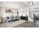 Bright dining room featuring a modern chandelier, neutral tones, and a staircase at 156 Marchmont Dr, Locust Grove, GA 30248