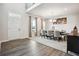 Dining area featuring wood floors, natural light, and view of the staircase at 156 Marchmont Dr, Locust Grove, GA 30248