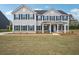 Attractive two-story house with blue shutters, a covered porch, and expansive front lawn at 156 Marchmont Dr, Locust Grove, GA 30248