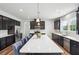 Spacious kitchen features an island with counter seating, stainless appliances, and hardwood flooring at 156 Marchmont Dr, Locust Grove, GA 30248