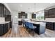 Modern kitchen with dark cabinets, quartz countertops, a large island, and stainless steel appliances at 156 Marchmont Dr, Locust Grove, GA 30248