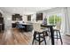 Bright kitchen features an island with counter seating, stainless appliances, and hardwood flooring at 156 Marchmont Dr, Locust Grove, GA 30248