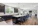 Open concept kitchen features a large island with barstool seating and wood floors at 156 Marchmont Dr, Locust Grove, GA 30248