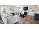 Comfortable living room features a fireplace with mantle, and a plush sectional sofa at 156 Marchmont Dr, Locust Grove, GA 30248